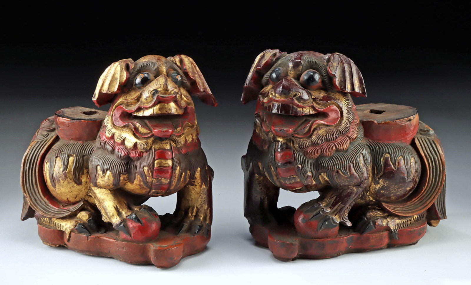 19th C. Qing Gilt Wood Fu Lion Stands w/ Tang Receptacles: East Asia, China, Qing Dynasty, ca. 19th century CE. A charming pair of gilt wooden stands, each in the form of a Fu dog seated on his haunches with one foreleg atop a ball representing material eleme