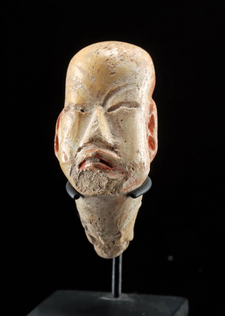 Olmec Pottery Head - Slitted Eyes and Downturned Lips: Pre-Columbian, Gulf Coast of Mexico, Olmec culture, Early to Middle Preclassic Period, ca. 1200 to 400 BCE. A compelling fragment of a terracotta figurine, depicting the head of a figure in the distin