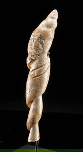 Colima Anthropomorphic Pendant Carved from Conch w/ Jade Inlay: Pre-Columbian, West Mexico, Colima culture, ca. 300 BCE to 300 CE. A remarkable pendant, intricately carved from the spire of a conch shell into an abstract anthropomorphic figure. The natural curvatu