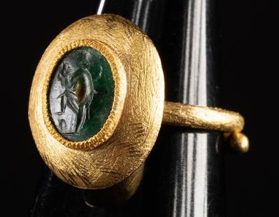 Roman Chalcedony Intaglio Dancing Satyr (in Gold Ring): Roman, Imperial period, intaglio, ca. 1st to 3rd century CE; Europe, ring, ca. 20th to 21st century CE. A striking green chalcedony intaglio of a dancing satyr holding a shepherd's crook and theatre m