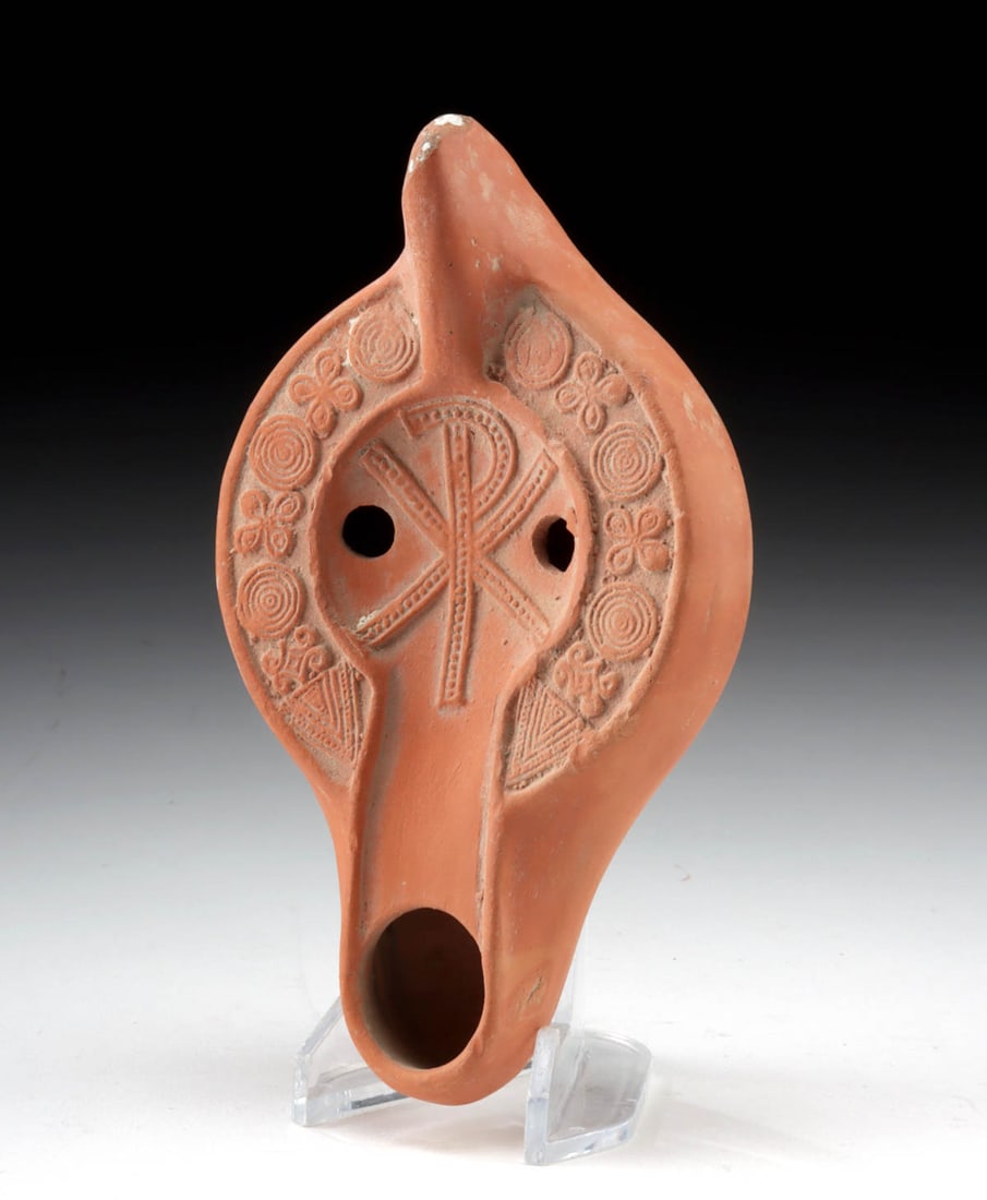 Roman N. African Redware Oil Lamp - Chi Rho: Roman, North Africa, Imperial to early Byzantine period, ca. 4th to 5th century CE. A delightful artifact of Byzantine daily life and spiritual devotion, this redware oil lamp features a central tondo