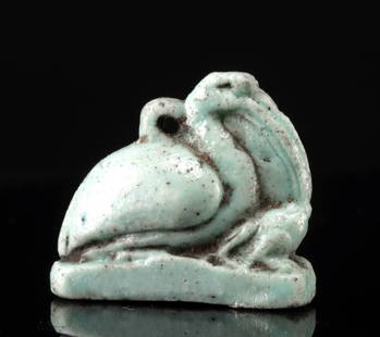 Egyptian Faience Amulet - Thoth as Ibis w/ Maat: Egypt, Second Intermediate period to New Kingdom, ca. 14th to 20th Dynasty, ca. 1705 to 1077 BCE. A charming, mold-made faience amulet featuring an ibis atop an integral plinth, with an eyelet suspens