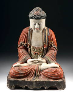 16th C. Chinese Ming Polychrome Wood Seated Buddha: East Asia, China, Ming Dynasty, ca. 16th century CE. A magnificent hand-carved wooden figure of Buddha Sakyamuni, seated in deep meditation atop a narrow, unadorned throne. His legs are crossed in pad