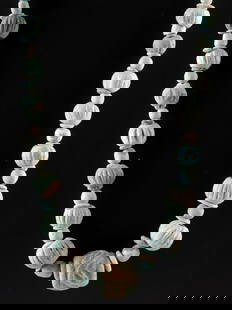 Wearable Ancient Egyptian Faience Melon Bead Necklace: Ancient Egypt, New Kingdom to Late Period, ca. 1539 to 30 BCE. A collection of ancient faience beads - including melon-shaped, disc, and spherical forms - graduated in size and strung on a modern mono