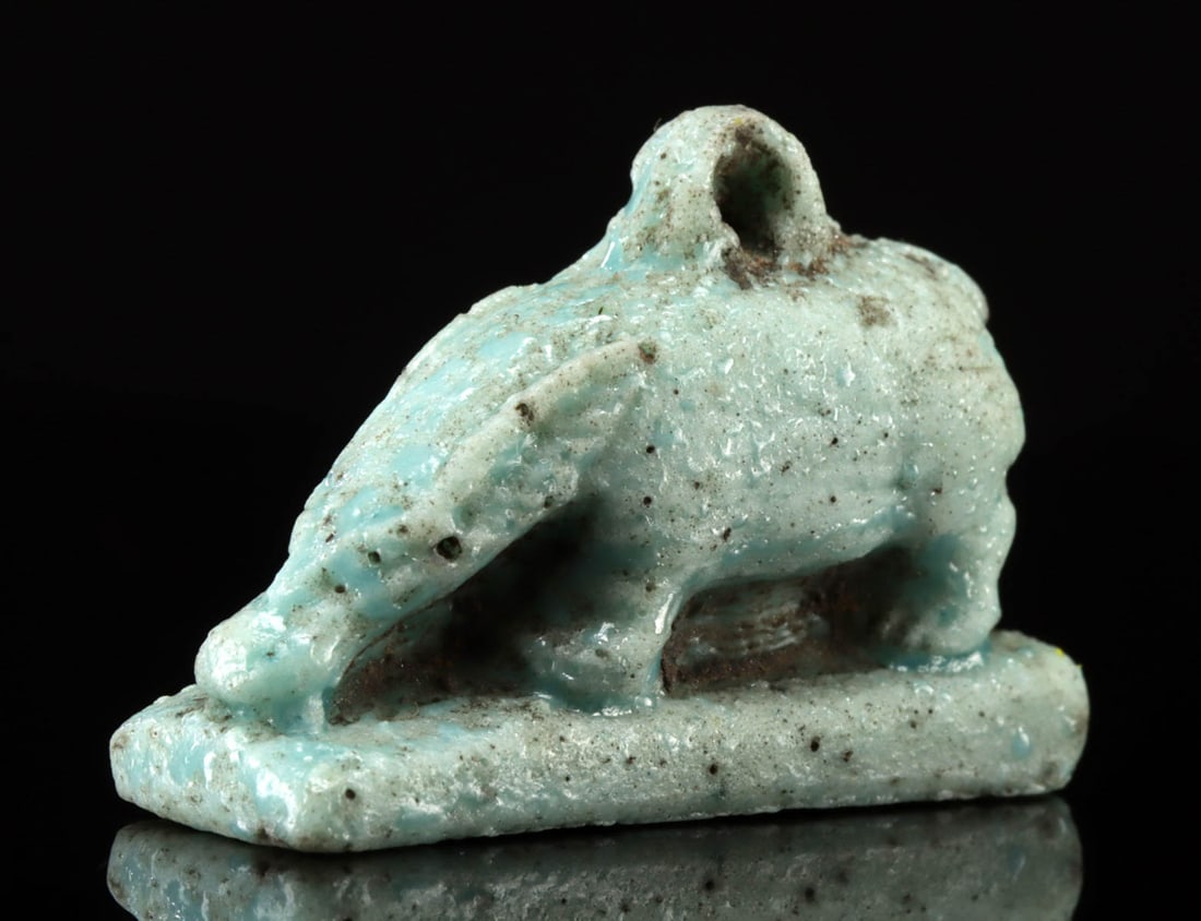 Egyptian Faience Amulet of Goddess Nut as a Sow: Egypt, Late Dynastic period, 26th to 31st Dynasty, ca. 672 to 332 BCE. A splendid faience amulet in the form of a sow standing on all fours with head bowed and a suspension loop rising from her back.