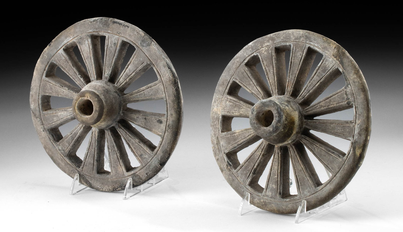 Han Dynasty Pair of Pottery Chariot Mingqi Wheels: East Asia, China, Han Dynasty, ca. 206 BCE to 220 CE. A matching pair of terracotta wheels from a funerary mingqi chariot - ritual models interred in tombs to serve the deceased in the afterlife. Each