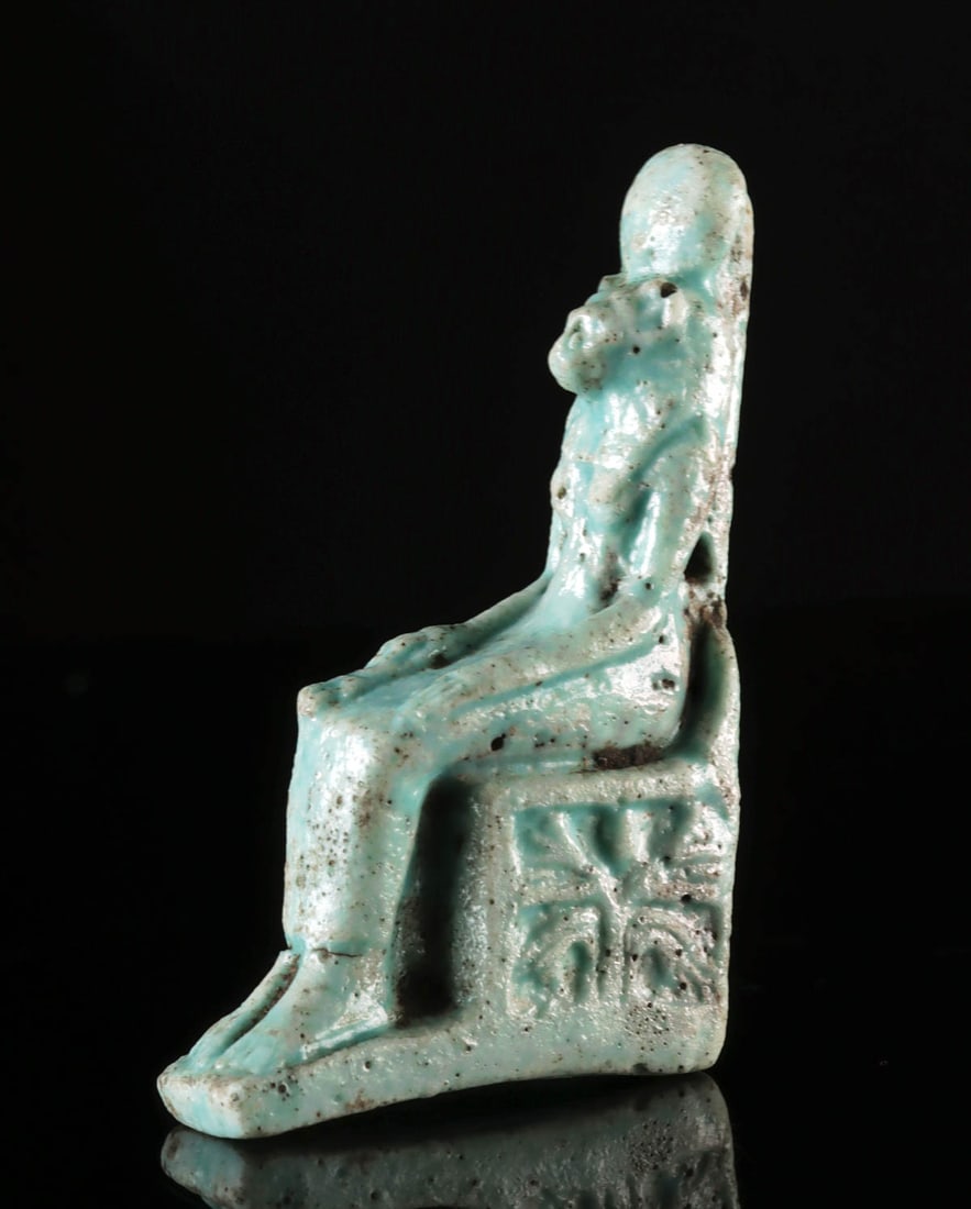 Very Fine Egyptian Faience Sekhmet on Throne: Ancient Egypt, Late Dynastic to Ptolemaic Period, ca. 664 to 30 BCE. A mold-made faience amulet depicting Sekhmet, the lioness-headed goddess of war, destruction, and healing, seated upon a throne. Sh