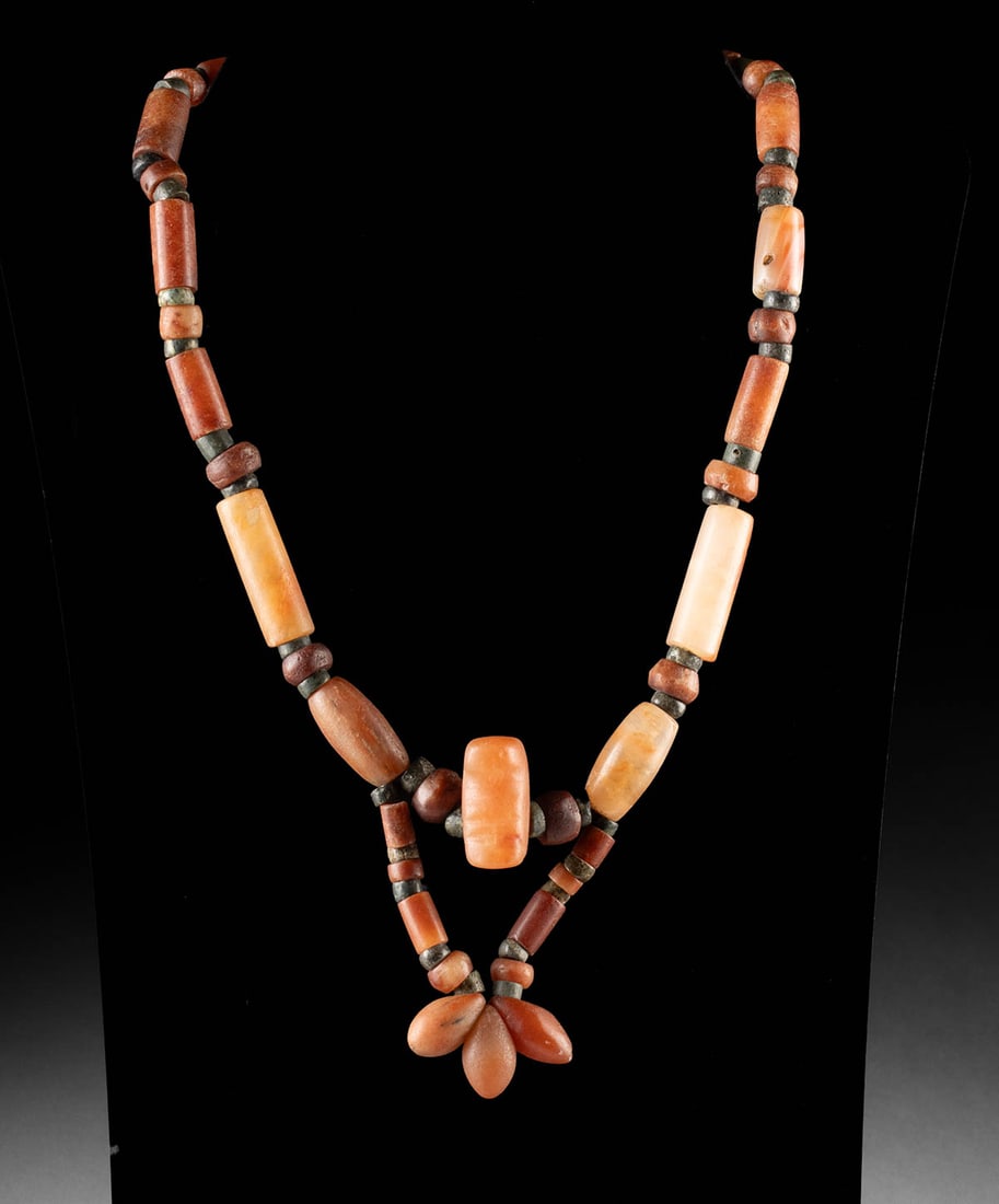Tairona Necklace of Carnelian & Greenstone Beads: Pre-Columbian, Colombia, Sinu (Zenu) or Tairona people, ca. 1000 to 1500 CE. A striking necklace composed of ancient green stone and carnelian beads. The beads are arranged alternating between the two