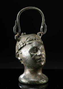 Roman Bronze Balsamarium of Nobleman, ex-Sotheby's: Roman, Imperial Period, ca. 1st to 3rd century CE. A finely cast Roman bronze Balsamarium, sculpted in the form of a youthful male head, possibly representing Dionysus (Bacchus) or a victorious youth,