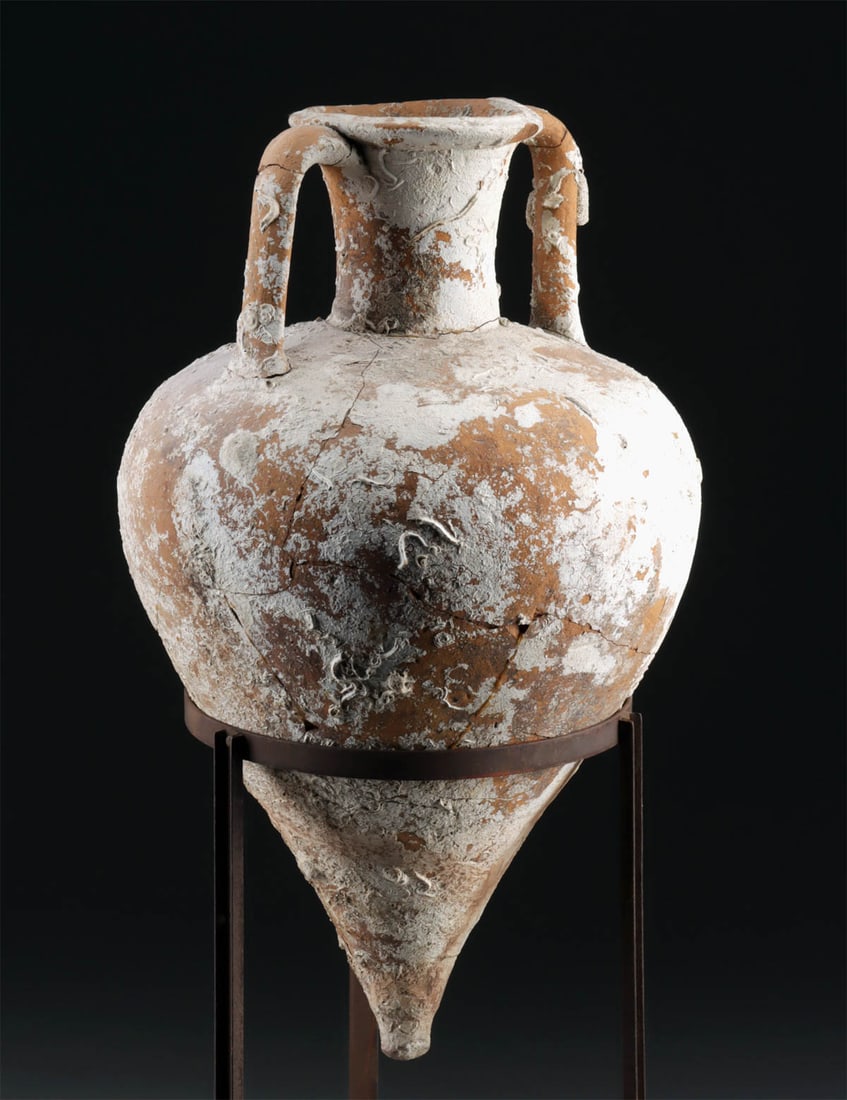 Hellenistic Aegean Shipwreck Amphora, ex-Ron Ely: Aegean Sea, Greece, Hellenistic, ca. 3rd to 2nd century BCE. A large maritime transport amphora, wheel-thrown with a sharply tapering conical base, bulbous body, tall cylindrical neck, and pair of app