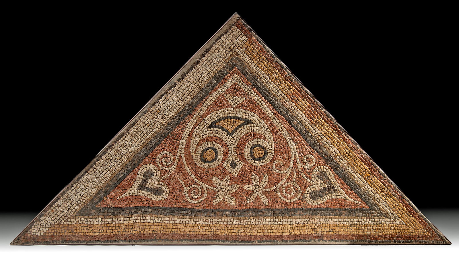 Late Roman / Early Byzatine Mosaic Spandrel: Eastern Mediterranean (modern-day Syria, Jordan, Israel, or Lebanon), ca. 4th?6th Century CE. A rare and visually striking architectural mosaic panel from the twilight of the Roman Empire, dating to t