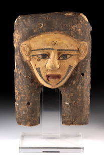 Egyptian Late Dynastic Wood Mummy Mask w/ Chinstraps: Egypt, Late Dynastic Period, 26th to 30th Dynasties, ca. 664 to 332 BCE. A striking funerary mask carved from wood and finished with gesso and painted decoration, created to adorn a mummified body