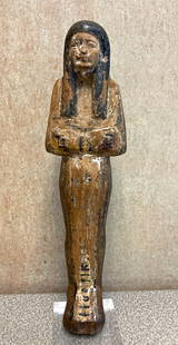 Egyptian Polychrome Wooden Shabti w/ Hieroglyphs: Ancient Egypt, New Kingdom to Third Intermediate Period, ca. 1550?712 BCE. A carved wooden shabti figure, painted in warm reddish-brown and black pigments, with faint remains of white gesso ground