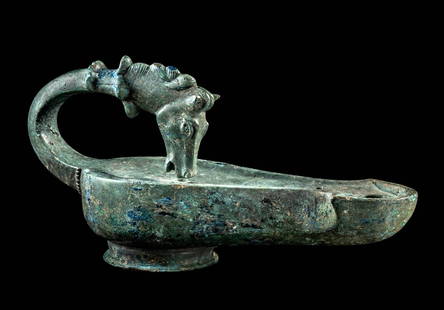 Roman Bronze Oil Lamp w/ Horse Head Handle: Roman Empire, ca. 1st to 3rd century CE. A superbly cast bronze oil lamp with a rounded reservoir, sharply angled spout, and sculptural handle surmounted by the head of a horse. The equine figure is r