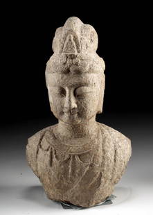 Chinese Tang Dynasty Stone Bust of Guanyin Goddess: East Asia, China, Tang to Song Dynasty, ca. 618 to 1279 CE. A carved bust fragment of Guanyin (Avalokiteshvara), the bodhisattva of compassion, rendered in a gray limestone. The noble figure displays