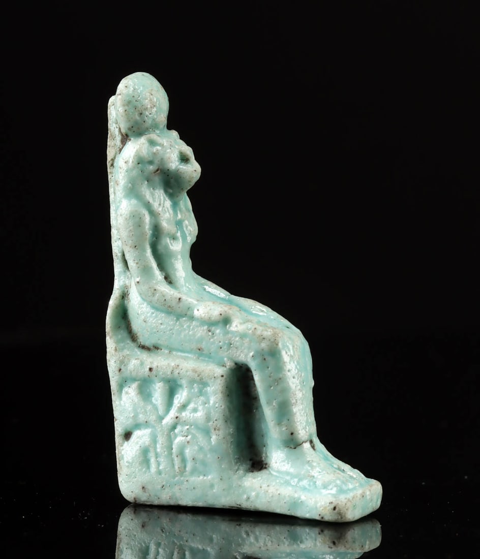 Egyptian Faience Sekhmet on Throne Amulet: Ancient Egypt, Late Dynastic Period, 26th to 31st Dynasty, ca. 664 to 332 BCE. A petite, green-glazed faience amulet depicting Sekhmet (occasionally Sakhmet, literally "the powerful one"), the lioness