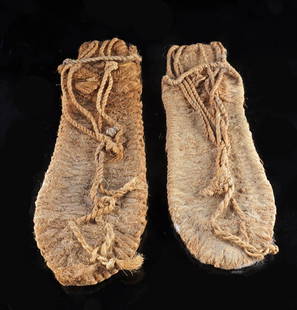 Ancient Native American Anasazi Woven Sandal Pair: Native American, Southwestern United States, Anasazi (Ancestral Puebloan), ca. 700 to 1350 CE. A rare and well-preserved pair of sandals, woven from plant fibers, likely yucca. Each sandal features a