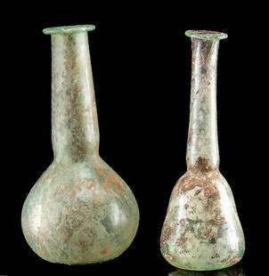 Two Ancient Roman Glass Unguentarium Vessels: **Originally Listed At $400** Roman, Imperial Period, ca. 1st to 3rd century CE. A delicate pair of free-blown glass flasks, or unguentariums, each crafted with a spherical body, a tall neck, and a
