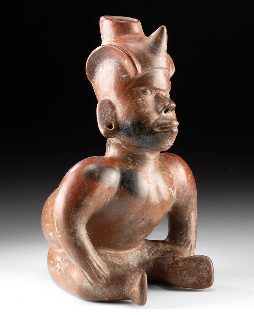 Colima Redware Vessel - Seated Hunchback Dwarf / Shaman: Pre-Columbian, West Mexico, Colima, Protoclassic to Classic period, ca. 100 BCE to 250 CE. A powerful Colima redware figural vessel in the form of a seated dwarf or hunchback shaman, modeled with bold