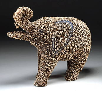 Rare Cameroon Elephant Effigy w/ Cowrie Shells & Beads: Central Africa, Cameroon, Bamileke / Bafou culture, ca. 19th to early 20th century CE. A rare and striking wooden elephant figure, meticulously adorned with hundreds of cowrie shells and multicolored