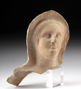 Etruscan Pottery Votive Head - Woman with Veil: Ancient Mediterranean, Italy, Etruscan, ca. 4th to 3rd century BCE. A molded terracotta votive head from ancient Etruria, depicting the stylized features of a veiled female figure. Her round face is f