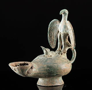 Roman-Byzantine Bronze Oil Lamp w/ Eagle & Rabbit: Roman, late Imperial Period to Byzantine Empire, ca. 4th to early 5th century CE. A cast bronze oil lamp featuring an eagle mid-hunt, perched over a startled rabbit emerging from the lid. This piece b