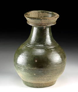 Ancient China Han Dynasty Stoneware Funerary Vessel: East Asia, China, Han Dynasty, ca. 206 BCE to 220 CE. A green-glazed stoneware jar of the hu type, traditionally used in tomb contexts for storing food or offerings to the deceased. The vessel display