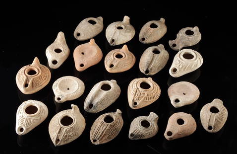Lot of 20 Holy Land Clay Oil Lamps, Roman to Byzantine: Ancient Near East, Levant, Roman to Byzantine Periods, ca. 1st to 7th century CE. A varied and appealing group of twenty terracotta oil lamps from the Holy Land, spanning a wide range of production ty