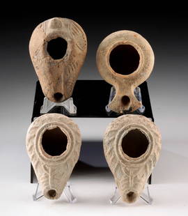 4 Holy Land Pottery Oil Lamps - Geometric Motifs: Ancient Near East, Levant, Roman to Byzantine Periods, ca. 1st to 6th century CE. A group of four mold-made pottery oil lamps from the ancient Holy Land, each exhibiting subtle variations in form, sur