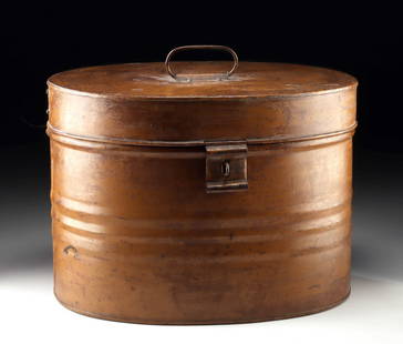 Victorian Era Metal Hat Box - Oval Traveling Case: United States / England, Victorian to Edwardian era, ca. 19th to early 20th century CE. An iron hat box featuring an oval form with a hinged lid and top handle, complete with its original clasp at the