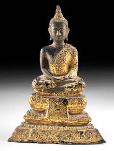 18th C. Thai Rattanakosin Gilt Brass Buddha Statue: Southeast Asia, Thailand, Rattanakosin period, ca. 18th to 19th century CE. A beautifully gilt and lacquered brass Buddha statue, cast over a pottery core, resting on a tall dais pedestal. The Buddha