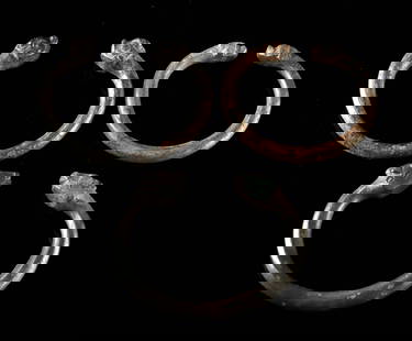 Ancient Achaemenid Bronze Bracelets Zoomorph Terminals: Near East / Central Asia, Turkey or Persia / Iran, Achaemenid, ca. 6th to 2nd century BCE. A group of three ancient cast bronze bracelets, each terminating in stylized zoomorphic heads, possibly repre