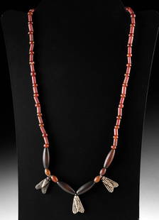 Ancient Egyptian Silver Fly Beaded Necklace: Ancient Egypt, Late Dynastic to Ptolemaic Period, ca. 664 to 30 BCE. A necklace featuring a strand of modern carnelian and glass beads, centered with three ancient silver fly pendants. The components