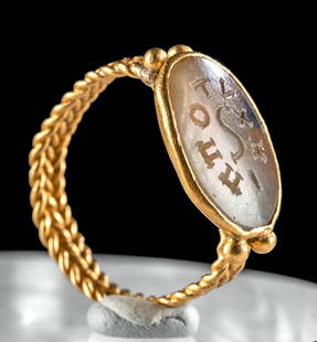 Byzantine Gold Ring Greek-Inscribed Chalcedony Intaglio: Near East, Byzantine, ca. 5th century CE. A magnificent gold signet ring of exceptionally high purity?over 23.5 karats?set with a finely carved chalcedony intaglio. The translucent stone bears a Greek