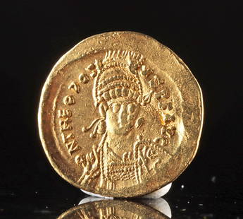 Roman/Byzantine Gold Solidus Coin of Theodosius II: Roman Empire, Byzantine era, ca. 443 to 450 CE. A gold solidus struck under Emperor Theodosius II, probably during the final years of his reign, at the imperial mint of Constantinople. The obverse pre