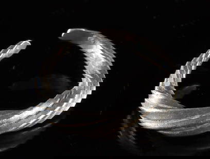 9th to 11th C. Viking Silver Ring - Spiral Form: Northern Europe, Scandinavia, Viking culture, ca. 9th to 11th century CE. A silver ring of powerful simplicity, hand-forged with a boldly twisted band tapering at the terminals to form an open loop. C