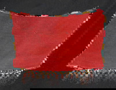 2000 Year Old Nazca Textile Trophy Head Munecas Fringe: Pre-Columbian, South Coast Peru, Nazca culture, ca. 100 to 300 CE. A remarkable handwoven textile made from colorful alpaca wool, featuring a rectangular central panel in vibrant red, bordered on one