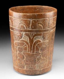 Classic Maya Carved Cylinder - Snake Motif and Figures: Pre-Columbian, Southern Mesoamerica, Maya, Classic Period, ca. 250 to 900 CE. A finely incised Maya pottery cylinder vessel, its surface alive with symbolic energy and carved detail. Burnished in warm
