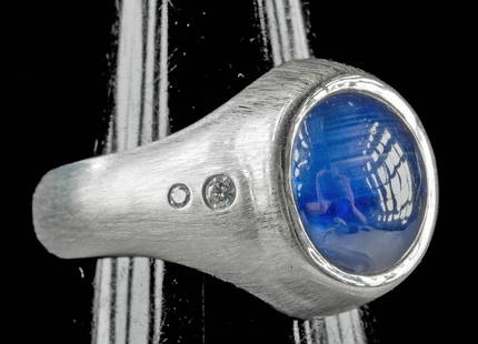 Burmese Star Sapphire 18K White Gold Ring w/ Diamonds: Burma, South Africa and Canada, contemporary. IA striking and important ring featuring a natural, unheated Burmese star sapphire from the famed Mogok mines. The vivid deep blue cabochon weighs 7.49 ca
