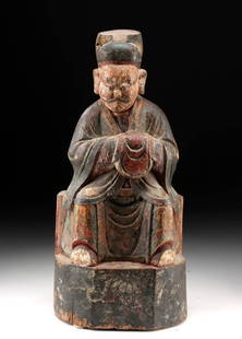 18th C. Chinese Qing Wood Wealth God - Offering Bag: East Asia, China, Qing Dynasty, ca. 18th century CE. An impressive hand-carved wooden figure of the Chinese God of Wealth, richly polychromed and dating to the Qing Dynasty, shown seated in full cerem