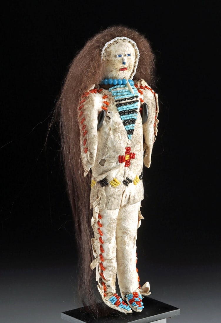 Late 19th C. Sioux Beaded Leather Doll Warrior: Native American, Western United States, Plains Tribes, likely Lakota / Dakota (Sioux) or Cheyenne, ca. late 19th to early 20th century CE. A handmade rawhide and beaded doll of a warrior man in tradit