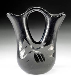 San Ildefonso Pueblo Blackware Wedding Vase: Native American, Southwestern United States, San Ildefonso Pueblo, ca. mid-20th century CE. A lovely wedding vase fired to a dark black hue, the exterior of the vessel exhibits an intense luster. The