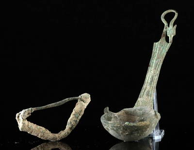 Ancient Roman Bronze Kyathos Style Ladle & Bow Fibula: Roman, Imperial Period, ca. 1st to 3rd century CE. Two bronze artifacts, including a fine bronze ladle and a bronze fibula brooch. The kyathos style ladle features a broad, shallow bowl with a thick r