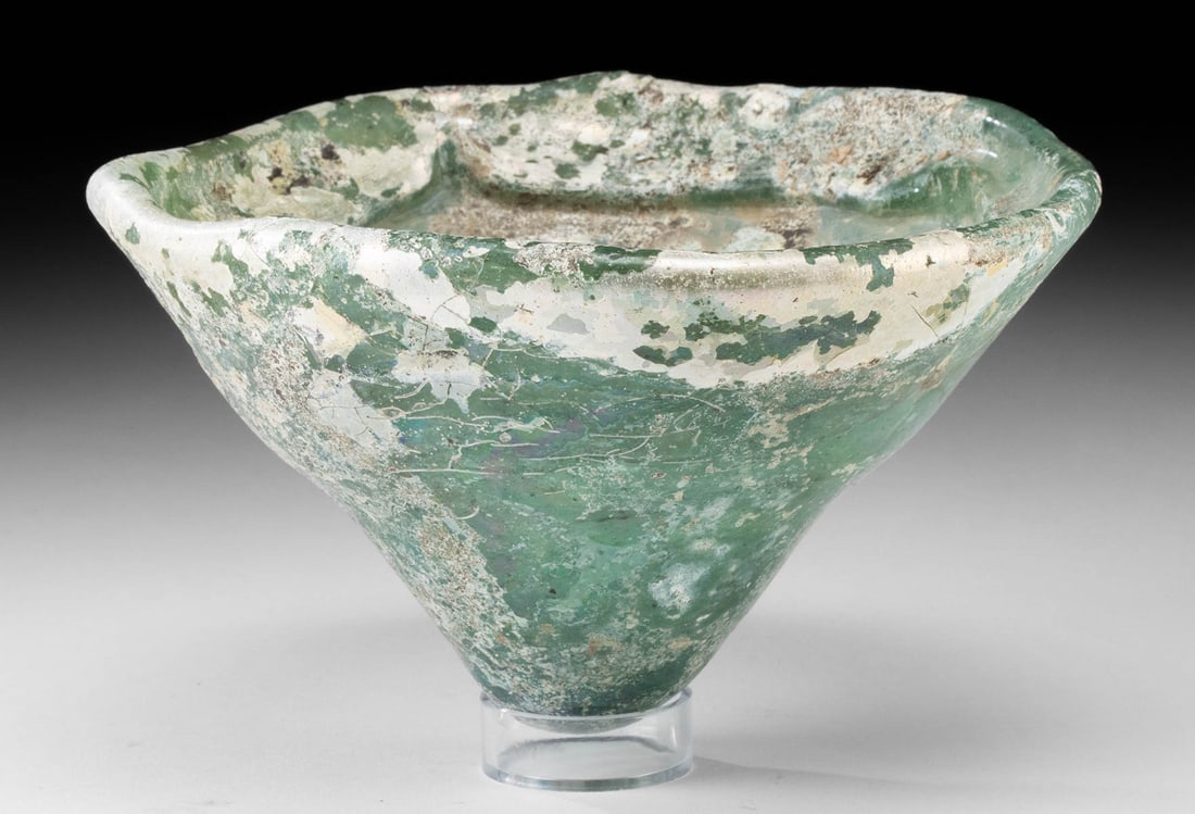 Ancient Byzantine Thick Glass Conical Oil Lamp Vessel: Ancient Near East, Early Byzantine Empire, ca. 5th to 10th century CE. A large aqua-green glass oil lamp of conical form, likely originally set within a bronze fixture. The lamp features a broad, inwa