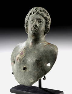 1st C. Roman Bronze Bust Applique of a Youth: Roman, Imperial period, ca. 1st to 3rd century CE. A dynamic and sensitively modeled copper alloy bust applique, once affixed to a larger object, likely a vessel, chariot, or piece of furniture, offer