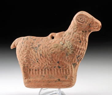 Whimsical Roman Terracotta Vessel - Stylized Ram Form: Roman, Imperial period, ca. 1st to 3rd century CE. A terracotta vessel of delightful whimsy and rustic elegance, molded in the form of a stylized sheep or ram. The vessel features a flattened body wit