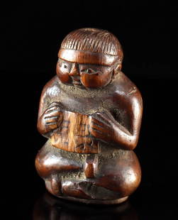 19th C. Chinese Qing Wood Boy-Form Belt Toggle: **Originally Listed At $100** East Asia, China, Qing Dynasty, ca. 19th century CE. A carved wooden dress toggle in the form of a young boy seated and holding a paper or scroll inscribed with character