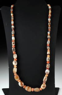 Bactrian Agate & Carnelian Bead Necklace: Ancient Central Asia, Bactrian, ca. 2nd millennium BCE. A luminous array of ancient artistry and enduring elegance, this necklace presents a strand of Bactrian agate and carnelian beads, each individu