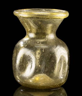 Fine & Intact Ancient Roman Dimpled Yellow Glass Jar: Roman, Imperial Period, ca. 3rd to 4th century CE. A translucent yellow glass jar, free-blown with a square body and pinched "dimpled" sides. The vessel rises from a rounded base and flares dramatical