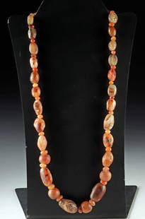 Ancient Gemstone Bead Necklace of Carnelian & Agate: Roman Empire, Egyptian, Near East, & Central Asian cultures, ca. 1000 BCE to 1000 CE. A strand of ancient gemstones, this necklace is composed of polished, naturally variegated carnelian, agate, and c